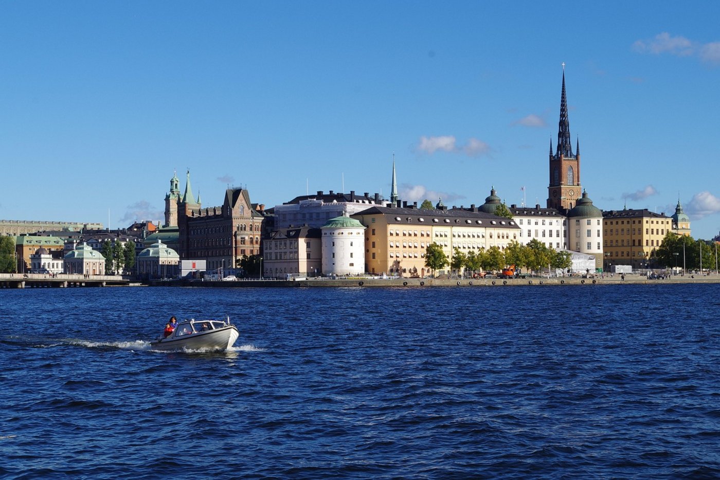 Blick auf das Stockholmer Schloss bei blauem Himmel vom Wasser aus.